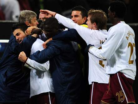 The team and Arsene embrace